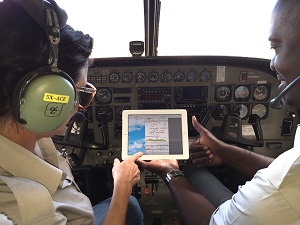Pilots in plane looking at ipad