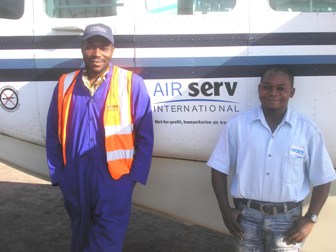 Congolese dedicated employees posing for picture by Air Serv plane